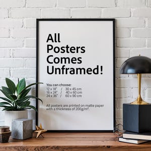 a poster on a table with a plant and a lamp