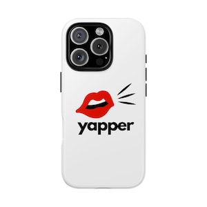 May include: White phone case featuring a red lip graphic and the word "yapper" in black. The case has a triple-lens camera system and black side accents.