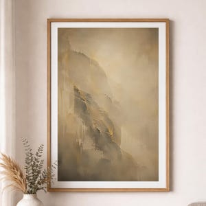 Könnte beinhalten: Ein vertikaler, rechteckiger Wandkunstdruck in einem hellen Holzrahmen mit einem abstrakten Gemälde in gemischten Beige-, Creme- und Dunkelgrautönen. Die Komposition zeigt texturierte, geschichtete Pinselstriche, die einen weichen, nebligen Effekt erzeugen.