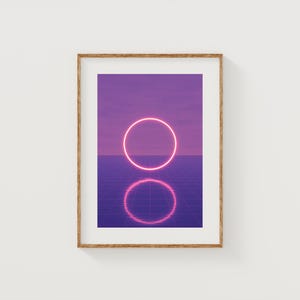 May include: A framed art print with a neon pink circle set against a purple gradient. The image has a retro, futuristic style, with a grid pattern in the lower section. The frame is made of light brown wood.