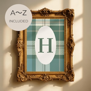 May include: A framed print with a gold ornate frame. The print features a teal and white plaid pattern with a white oval in the center containing the letter "H" in teal. A circular sticker in the upper left corner reads "A~Z INCLUDED".