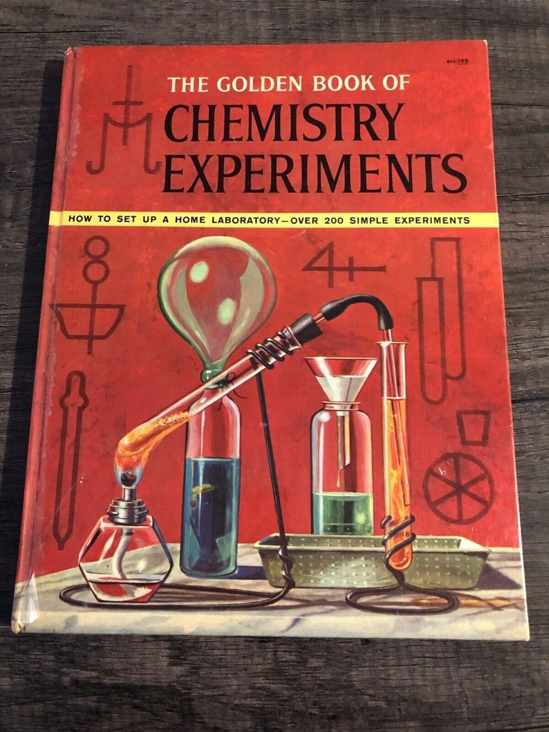 May include: The Golden Book of Chemistry Experiments, a red book with a yellow banner that reads 'How to Set Up a Home Laboratory - Over 200 Simple Experiments'. The cover features a colorful illustration of a chemistry experiment with beakers, a funnel, and a burner. The book is for ages 4 and up.