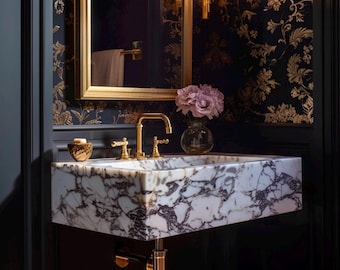 May include: A white marble bathroom sink with gold-toned faucets and a decorative soap dish. The sink is mounted on a black wall with a floral wallpaper pattern.