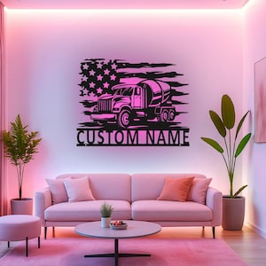 May include: A black metal wall art piece featuring a cement mixer truck silhouette layered over a distressed American flag design. The text CUSTOM NAME is displayed in bold capital letters at the bottom of the rectangular metal cutout.