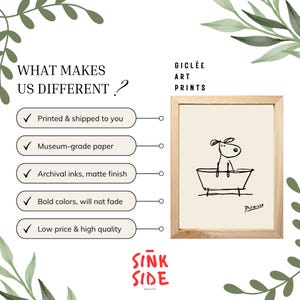 May include: A framed gicl&eacute;e art print featuring a minimalist black and white line drawing of a dog in a bathtub. The print is on museum-grade paper with archival inks and a matte finish. The frame is made of light-colored wood. The text on the image says "WHAT MAKES US DIFFERENT?"