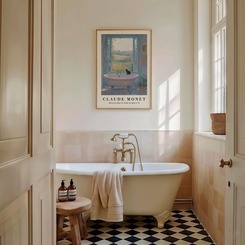 May include: A bathroom featuring a freestanding bathtub with brass taps and a wooden stool. A framed print of a Claude Monet painting is on the wall. The floor has a black and white chequered pattern. Two brown bottles are on the stool.