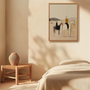 May include: Abstract art print in a wooden frame. The artwork depicts riders on horseback in a minimalist style, using black, beige, and yellow tones. The scene is set against a neutral background, creating a serene and artistic aesthetic.