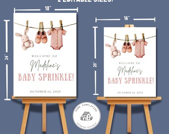 Op de afbeelding: Twee babyborrelborden op houten ezels. De borden zijn wit met roze tekst met de tekst "Welkom bij Madeline's Baby Sprinkle!" en de datum. Eén bord is 45,7 x 61 cm, de andere is 40,6 x 50,8 cm.