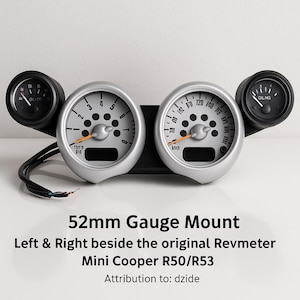May include: A 52mm gauge mount for a Mini Cooper R50/R53. The mount has two silver-faced gauges with black details and a black base. Two smaller gauges are on the sides. The text "52mm Gauge Mount" is visible.