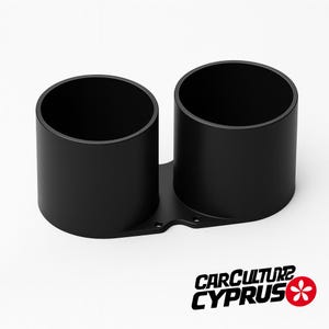 Puede incluir: Soporte de doble calibre negro con dos aberturas cilíndricas. El soporte está montado sobre una base plana con varios orificios de montaje. El logotipo "CARCULTURE CYPRUS" es visible en la esquina inferior derecha.