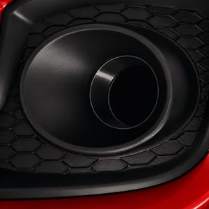 May include: A red car bumper featuring a black circular fog light housing surrounded by a matte black hexagonal honeycomb grille pattern. The text CarCultureCyprus is printed in white in the bottom right corner of the image.
