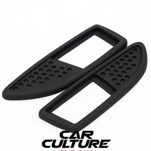 May include: Two black car interior trim pieces. Each piece has a rectangular frame with a perforated section. The text "CAR CULTURE" is visible in the lower right corner.