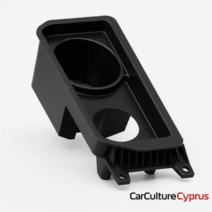 May include: A black car console cup holder with a rectangular design. It features a circular cup holder, a smaller circular opening, and a textured lower section. The product is made of plastic.