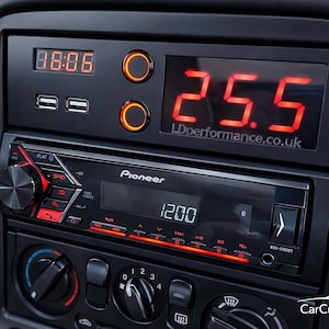 May include: Car dashboard with a Pioneer stereo, digital clock, and temperature display. The clock shows 88:08, and the temperature reads 25.5. Two USB ports are visible above the stereo.