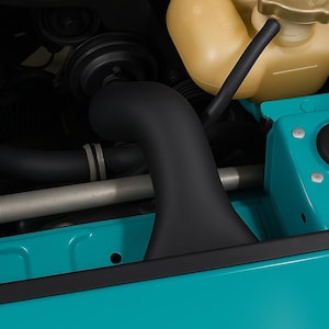 Può includere: Componenti del vano motore di un'auto, con un tubo di aspirazione nero, un serbatoio del liquido di raffreddamento giallo e pannelli della carrozzeria turchese. Il testo "CarCultureCyprus" è visibile in bianco.