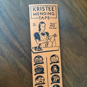 May include: A vintage box of KRISTEE MENDING TAPE with a woman ironing a garment. The box features the text "Mend While You Iron!" and illustrations of various mending uses, including socks, underwear, dresses, and pillowcases. The box is labeled "No. 614" and "THE KRISTEE PRODUCTS CO. Akron, Ohio."