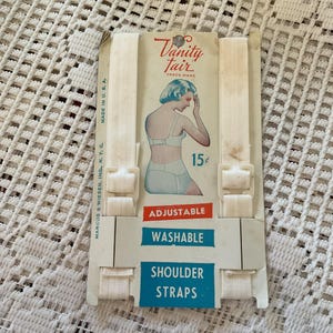 Spalline vintage anni '40-'50 per lingerie/reggiseno, bianco sporco, scorte morte su cartoncino espositivo originale *Vanity Fair*, regolabili, lavabili