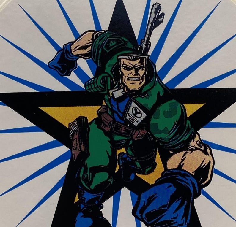 May include: A cartoon illustration of a soldier in a green camouflage uniform with a blue and black glove. The soldier is holding a rifle and is standing in front of a yellow star with a blue and white background.