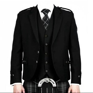 May include: A black kilt jacket with a matching waistcoat and a black and white patterned tie. The jacket features two buttons and epaulettes. The kilt is a grey and black tartan pattern.