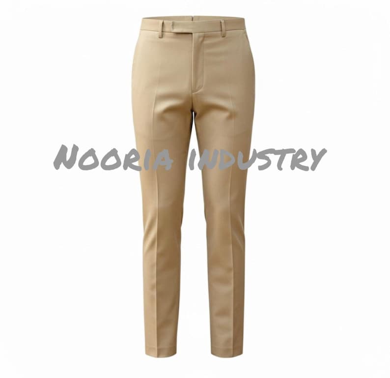 May include: Tan-colored dress pants with a straight leg and a belt loop waistband. The pants have a classic design and are made of a smooth fabric. The text "NOORIA INDUSTRY" is printed across the pants.