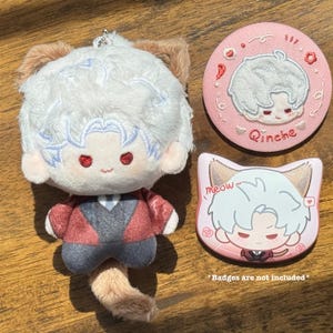 May include: A plush doll with white hair, red eyes, and a red and gray outfit. Two pink badges with the same character design are also shown. One badge is round and the other is cat-shaped, with the word "meow" on it.