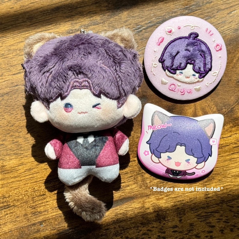 May include: A plush doll with purple hair and a red jacket, accompanied by two matching pins. One pin is round with the name "Qiyu", and the other is cat-shaped with the word "meow". The text "Badges are not included" is also visible.