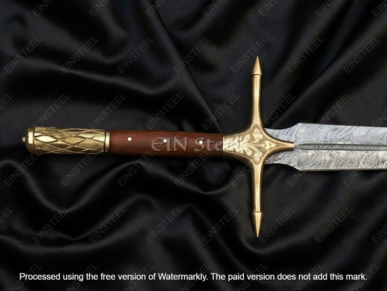 May include: A detailed view of a sword with a wooden handle and a gold-colored crossguard. The blade has a patterned design. The handle is dark brown with a gold-colored end. The sword is displayed on a black background.