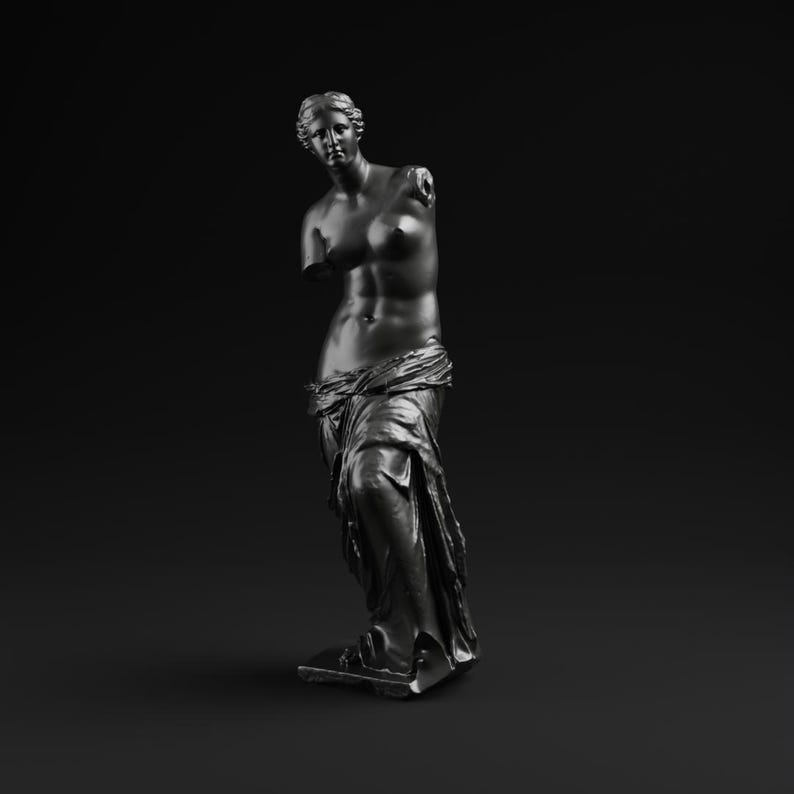 May include: A dark gray statue of Venus de Milo, a classical sculpture, stands against a black background. The statue is missing both arms and is draped in fabric around the lower body. The sculpture is a representation of classical art.
