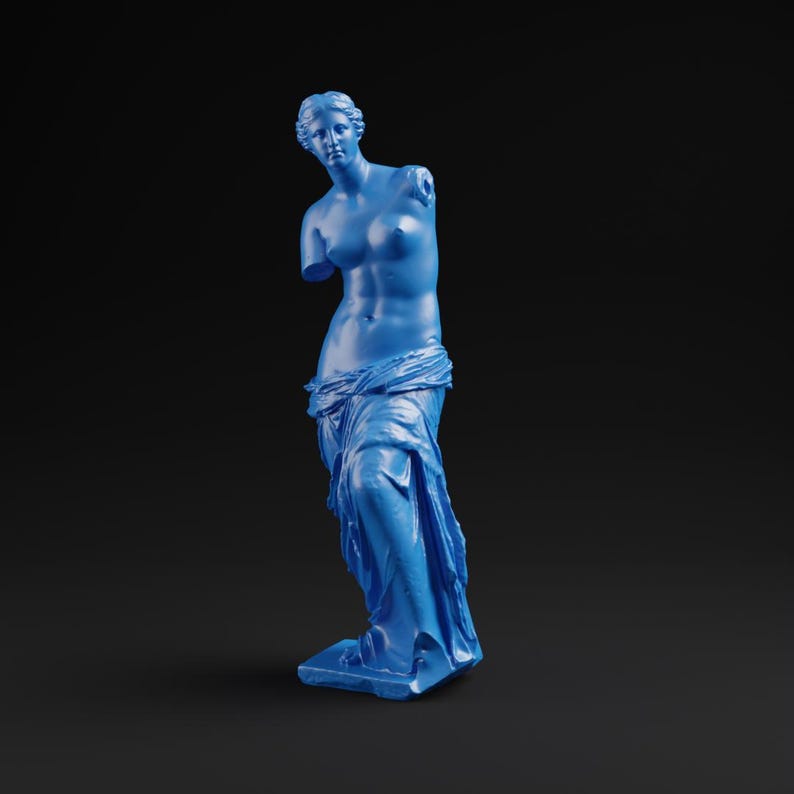 May include: A blue statue of Venus de Milo, a classical sculpture, stands against a black background. The statue is missing both arms and is draped in flowing fabric. The sculpture is a solid, monochromatic blue.