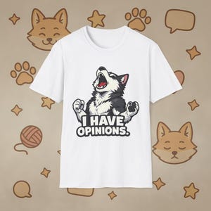 May include: White t-shirt featuring a graphic of a howling husky with the text "I HAVE OPINIONS." The husky is black, white, and gray with a red mouth. The shirt is a crew neck style.
