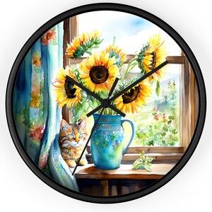 May include: Round wall clock with a black frame featuring a watercolor painting of sunflowers in a blue vase by a window. A tabby cat is nestled near the window. The clock hands are black.