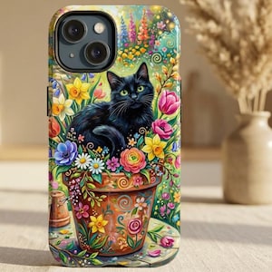 May include: A phone case featuring a black cat with green eyes nestled in a flower pot overflowing with colorful blooms. The design includes a vibrant garden scene with tulips, daisies, and other flowers, set against a soft background.