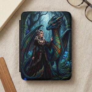 May include: A fantasy-themed tablet case featuring a woman in a burgundy dress and a teal dragon in a forest setting. The dragon has intricate gold and teal patterns. The case is black with a magnetic closure.