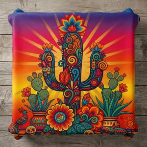 May include: A vibrant, decorative pillow featuring a colorful cactus design. The artwork includes a central cactus with intricate floral patterns, surrounded by blooming flowers, cacti, and a roadrunner. The background transitions from orange to purple.