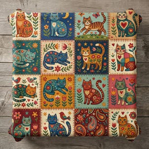 May include: Square throw pillow with a patchwork design featuring colorful cat illustrations. Each square showcases a different cat with floral and heart motifs, set against a background of flowers, birds, and paisley patterns. The pillow has a decorative edge.