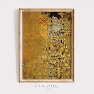 May include: A framed print of a painting depicting a woman in a gold and white dress with a geometric pattern. The background is a gold and yellow color.