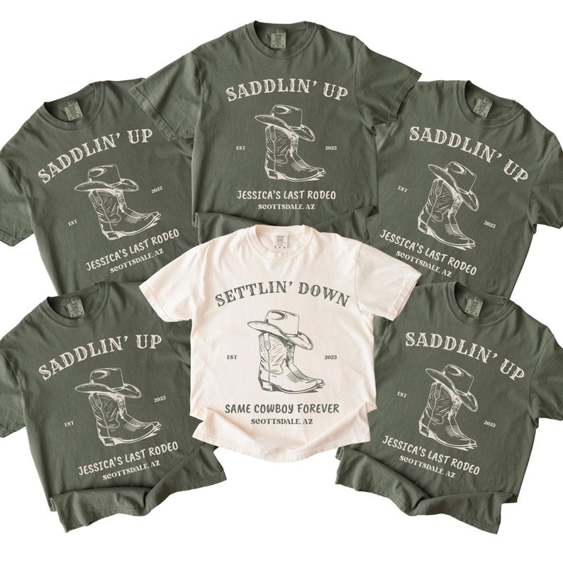 May include: Five olive green t-shirts and one cream t-shirt featuring a graphic of a cowboy hat and boot. The olive shirts read SADDLIN' UP, JESSICA'S LAST RODEO, SCOTTSDALE, AZ. The cream shirt reads SETTLIN' DOWN, SAME COWBOY FOREVER, SCOTTSDALE, AZ.