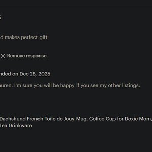 May include: A review of a Dachshund French Toile de Jouy Mug. The mug is beige with a pink interior and handle. The review states the mug is cute and a perfect gift. The image also includes text from the seller.