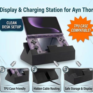 May include: A black display and charging station for the Ayn Thor handheld console. The station features a slot for the device, hidden cable routing, and is compatible with TPU cases. Text includes Display & Charging Station for Ayn Thor, CLEAN DESK SETUP, TPU CASE COMPATIBLE!, TPU Case Friendly, Hidden Cable Routing, and Safe Storage & Display.