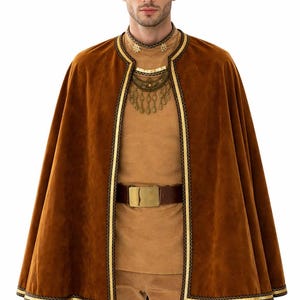 May include: A brown velvet cape with gold trim and a matching brown outfit. The costume includes a brown belt with a gold buckle and a decorative necklace. The outfit is suitable for a costume party or theatrical performance.