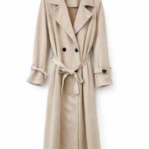 May include: A beige trench coat with a double-breasted design, featuring a notched collar, long sleeves, and a matching belt tied at the waist. The coat has black buttons and cuff details, offering a classic and elegant look.
