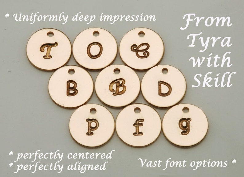 May include: A set of ten round, gold-colored metal discs with various letters engraved on them. The letters are "T", "O", "E", "B", "B", "D", "P", "f", and "g". The text "From Tyra with Skill" is written in cursive script in the upper right corner of the image. The text "* Uniformly deep impression * perfectly centered * perfectly aligned * Vast font options *" is written in cursive script at the top and bottom of the image.