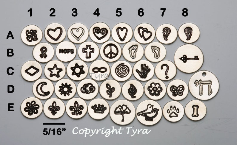 May include: A set of 40 silver metal charm discs with various symbols and designs, including hearts, stars, peace signs, and religious symbols. The discs are 5/16 inches in diameter. Copyright Tyra.