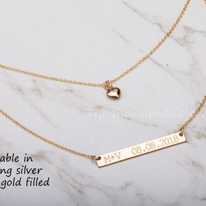 May include: Gold layered necklace with a small heart charm and a bar pendant engraved with "M+V 08.08.2018". Available in sterling silver or 14k gold filled.