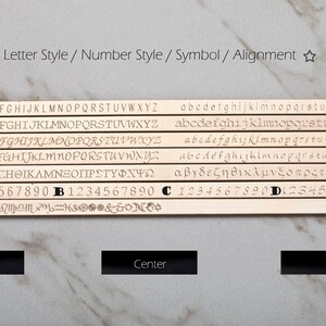 May include: A display of engraved metal strips showcasing various fonts, numbers, symbols, and alignment options. The image includes examples of uppercase and lowercase letters, numbers, and symbols, with options for left, center, and right alignment.