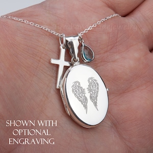 May include: Silver locket necklace with an angel wings engraving, a cross charm, and a light blue teardrop charm. Shown with optional engraving.