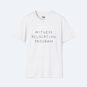 May include: White t-shirt with the text "WITNESS RELOCATION PROGRAM" in black, centered on the front. The shirt has short sleeves and a crew neck. The brand logo is visible at the top.