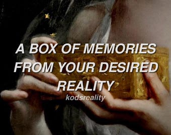 May include: A rectangular gold-coloured box with an ornate, textured surface. The text A BOX OF MEMORIES FROM YOUR DESIRED REALITY is printed in white capital letters across the centre, with the word kodsreality below it in smaller font.