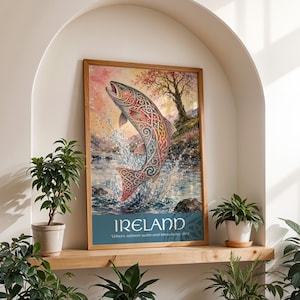 May include: A framed print depicting a salmon leaping from water, adorned with Celtic knot designs. The artwork has a colourful palette, with the word "IRELAND" at the bottom. The print is displayed on a wooden shelf with potted plants.