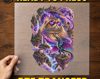 May include: A DTF transfer sheet featuring a graphic of a fluffy cat wearing purple-tinted sunglasses, positioned above a winged dinosaur on a floating island. The scene includes waterfalls, pine trees, a large moon, and cosmic nebula clouds.